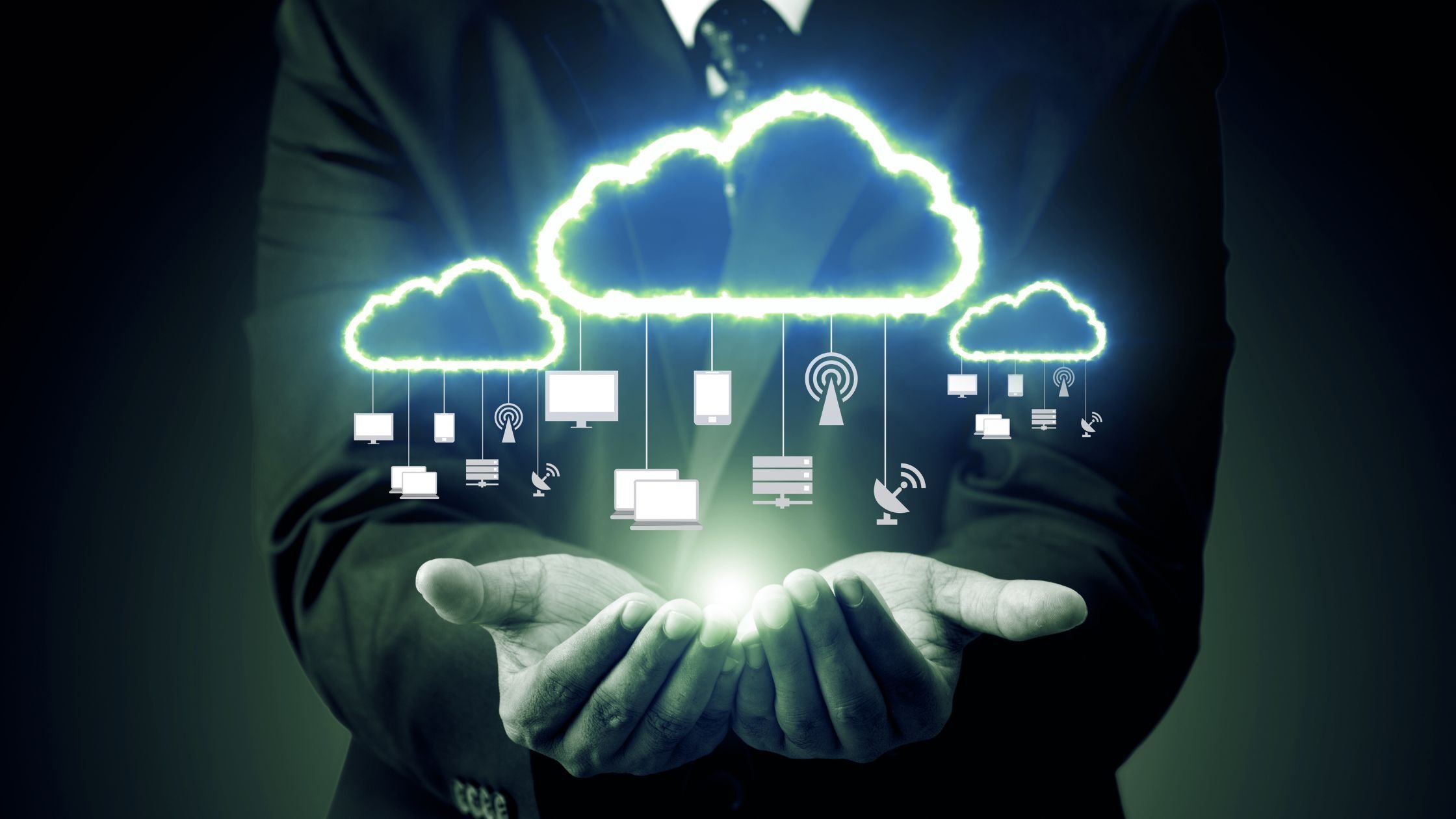 A businessman holds a cloud computing icon, symbolising cloud application modernisation and digital transformation.
