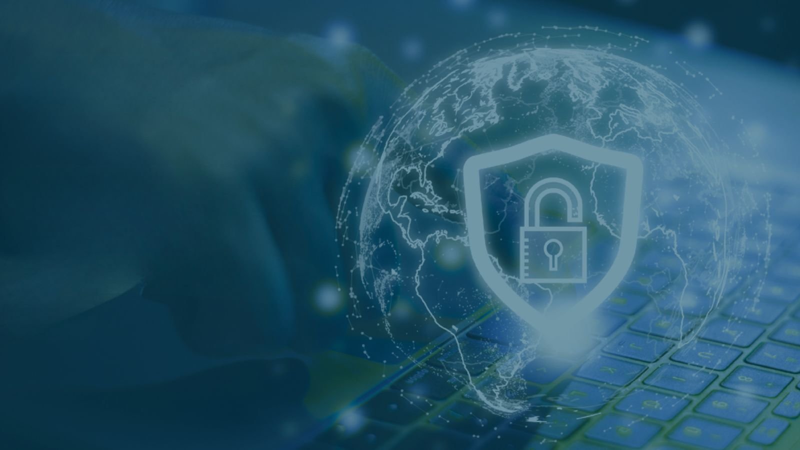 A global digital security concept featuring a translucent globe and a shield icon with a padlock overlaid on a blue-toned image of a person typing on a laptop keyboard.